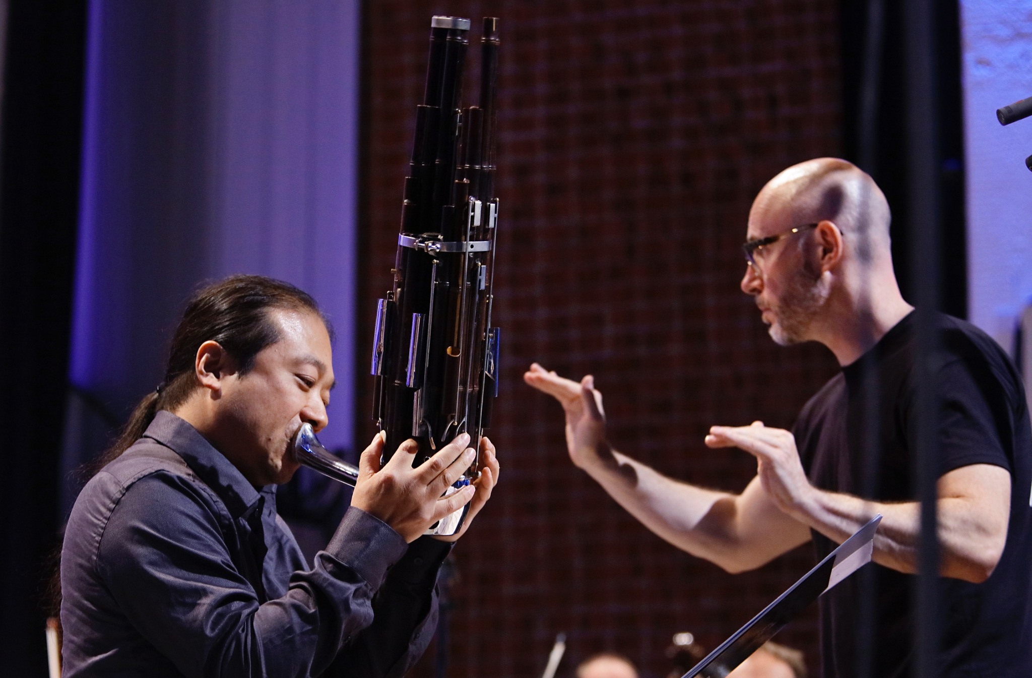 Wu Wei performing with conductor and orchestra